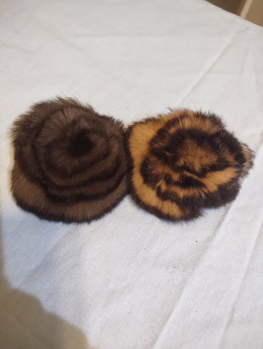 brown rosette pins made from either rabbit or mink fur.